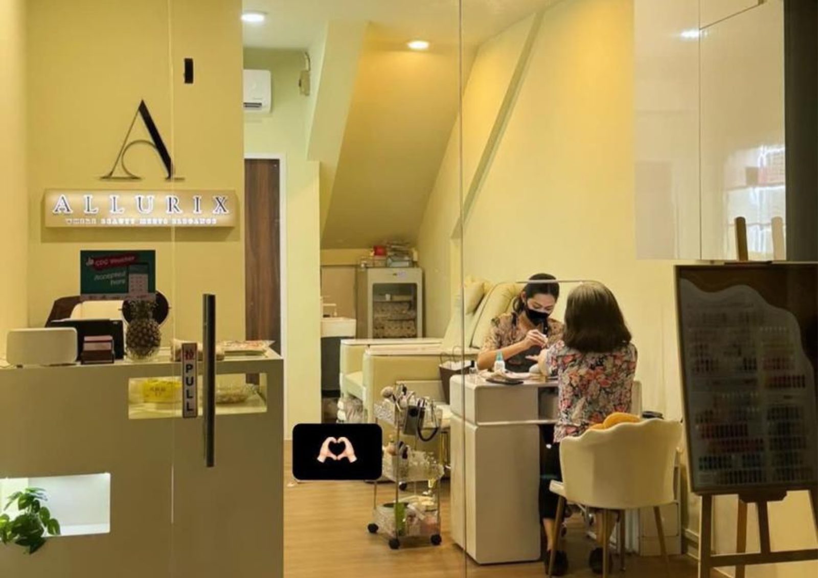 The salon interior with the Allurix sign above the counter